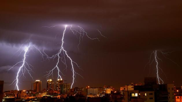 Lightning strikes the sky above the Israeli coastal city of Netanya, north of Tel Aviv. (Jack Guez / AFP) Lightning strikes the sky above the Israeli coastal city of Netanya, north of Tel Aviv. (Jack Guez / AFP)