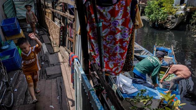 Children play on a walkway to a house on the banks of the Xuyen Tam canal in Ho Chi Minh City. “I’ve sent several complaint letters to central and local authorities but received no response,” the former police officer told AFP. (Kao Nguyen / AFP)