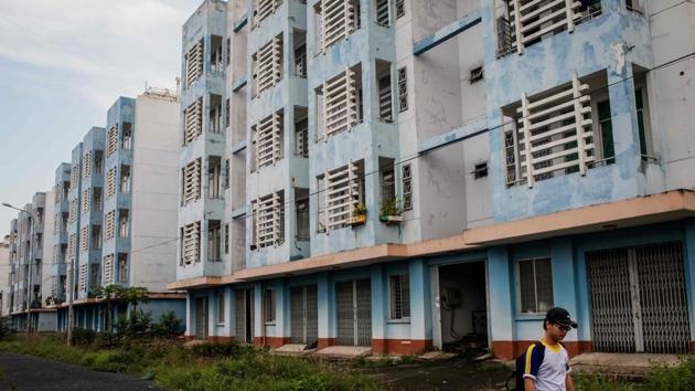 A man walk past state housing built for informal canal dwellers. The relocations have not been easy for some former canal residents like Nguyen Van Muc, who said he was forced to move three years ago. His new house, though outfitted with ceramic tiled floors and plastered walls, is half the size of his old clapboard model on Nuoc Len canal -- and 20 kilometres away. (Kao Nguyen / AFP)