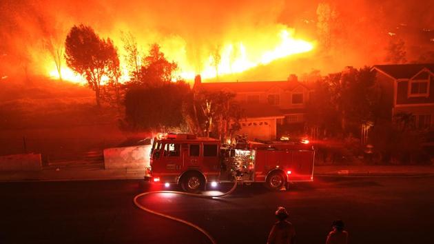 The remains of five of the victims were discovered in or near burned out cars, three outside residences and one inside a home, officials said. Another 35 people had been reported missing and three firefighters had been injured.(AFP)