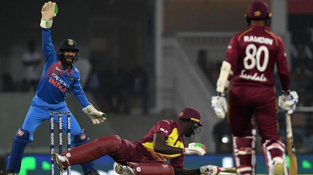 West Indies batsman Carlos Brathwaite (C) falls as Indian wicketkeeper Dinesh Karthik (L) reacts with West Indies batsman Denesh Ramdin (R) looking on during the second T20 cricket (AFP) West Indies batsman Carlos Brathwaite (C) falls as Indian wicketkeeper Dinesh Karthik (L) reacts with West Indies batsman Denesh Ramdin (R) looking on during the second T20 cricket (AFP)