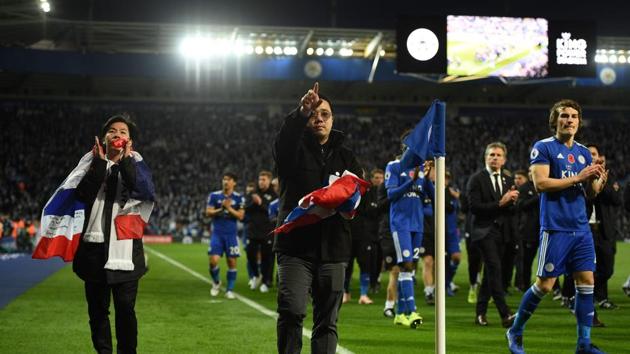 Apichet Srivaddhanaprabha (L) and Aiyawatt Srivaddhanaprabha (C) the sons of Leicester City's late Thai chairman Vichai Srivaddhanaprabha applaud the fans following the English Premier League football match between Leicester City and Burnley at King Power Stadium in Leicester.(AFP)