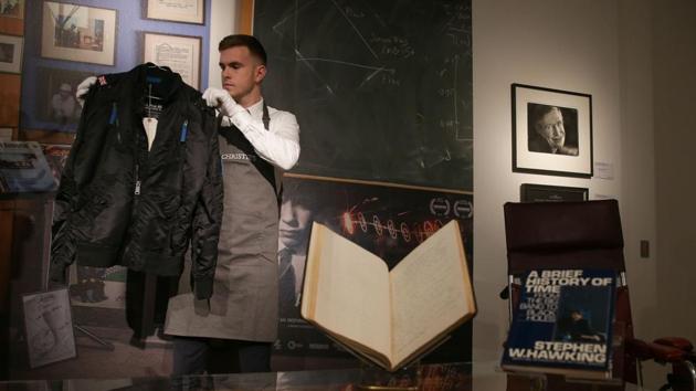 A gallery assistant poses with a bomber jacket that belonged to the late British theoretical physicist. A script from one of his appearances on the TV series “The Simpsons” was one of the 22 lots under the hammer, selling for £6,250. The collection highlighted the brilliance, determination and sense of humour of Hawking, who died in March aged 76. (Daniel Leal-Olivas / AFP File)