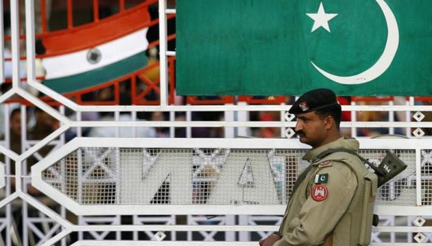 A Pakistani Ranger stands near the Pakistani flag and Indian flag (L) during a daily parade at the Pakistan-India joint check post at Wagah border, on the outskirts of Lahore February 26, 2010.(REUTERS) A Pakistani Ranger stands near the Pakistani flag and Indian flag (L) during a daily parade at the Pakistan-India joint check post at Wagah border, on the outskirts of Lahore February 26, 2010.(REUTERS)