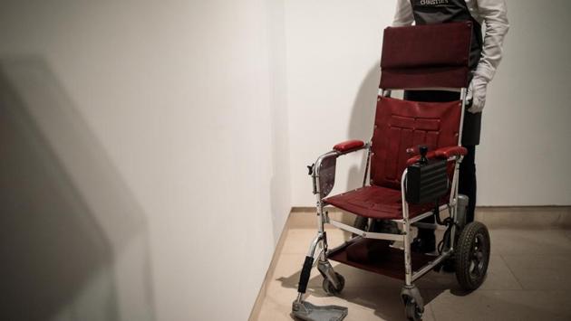 A red leather wheelchair that Hawking used from the late 1980s to the mid-1990s, driving himself using a joystick, sold for £296,750 while an early edition of his bestselling book “A Brief History of Time” marked with a thumbprint, fetched £68,750. (Jack Taylor / Getty Images)