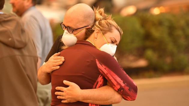 Two people embrace in the parking lot of the Feather River Hospital as it burns. Just 160km north of Paradise, the sixth most destructive wildfire in California history hit in July and August and was also one of the earliest. Called the Carr Fire, near Redding, it killed eight people, burned about 1,100 homes and consumed 927 square kilometers before it was contained. (Josh Edelson / AFP) Two people embrace in the parking lot of the Feather River Hospital as it burns. Just 160km north of Paradise, the sixth most destructive wildfire in California history hit in July and August and was also one of the earliest. Called the Carr Fire, near Redding, it killed eight people, burned about 1,100 homes and consumed 927 square kilometers before it was contained. (Josh Edelson / AFP)