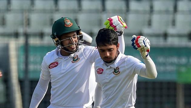 Bangladesh cricketer Mominul Haque (R) celebrates his century with teammate Mushfiqur Rahim (L) during the first day of the second Test cricket match between Bangladesh and Zimbabwe at the Sher-e-Bangla National Cricket Stadium in Dhaka(AFP)