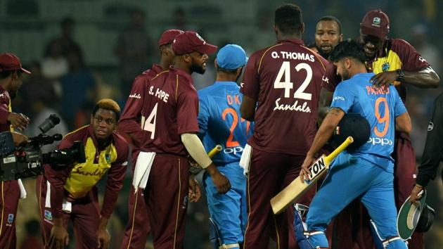 West Indies T20 cricket captain Carlos Brathwaite (R) hugs to congratulate Indian crickter Manish Pandey (2R) after their loss during the Third T20 cricket match between India and West Indies at the MA Chidambaram Cricket Stadium in Chennai. (AFP)