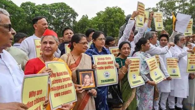 Trinamool Congress and Samajwadi Party members hold placards during a protest over the Assam NRC issue at Parliament House in New Delhi on July 31.(PTI Photo)