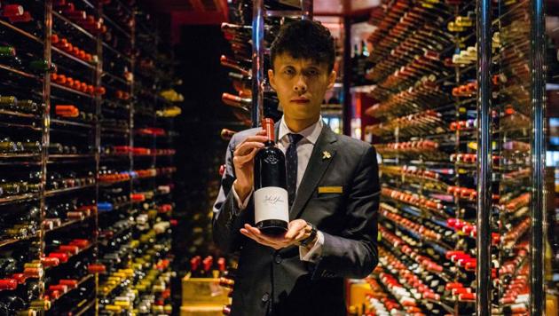 Assistant sommelier Felix Ho Ho Yua poses with a 2014 bottle of Ao Yun red wine at the Robuchon restaurant wine cellar in Hong Kong. A $300 bottle of wine sold in the United States and Europe is made in the unlikeliest of places, at the foot of the Himalayas in China. A stone’s throw away from Tibet, Ao Yun’s vineyards are located beneath the sacred Meili Mountain at altitudes ranging up from 2,200 metres in Yunnan. (Anthony Wallace / AFP) Assistant sommelier Felix Ho Ho Yua poses with a 2014 bottle of Ao Yun red wine at the Robuchon restaurant wine cellar in Hong Kong. A $300 bottle of wine sold in the United States and Europe is made in the unlikeliest of places, at the foot of the Himalayas in China. A stone’s throw away from Tibet, Ao Yun’s vineyards are located beneath the sacred Meili Mountain at altitudes ranging up from 2,200 metres in Yunnan. (Anthony Wallace / AFP)