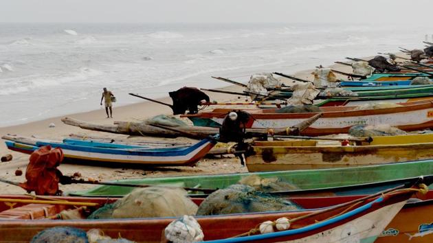 An Indian fisherman walks along a beach beside fishing boats on the coast of the Bay of Bengal in Chennai.(AFP)