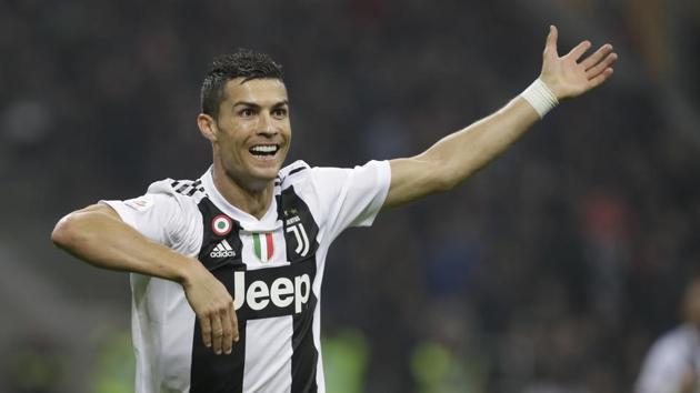 Juventus' Cristiano Ronaldo celebrates after he scored his side's second goal during a Serie A soccer match between AC Milan and Juventus, at Milan's San Siro stadium(AP)