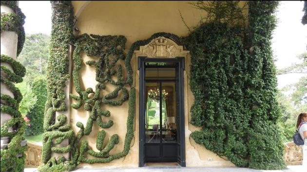 The villa is bathed in greenery and surrounded by the deep blue waters of the stunning lake.