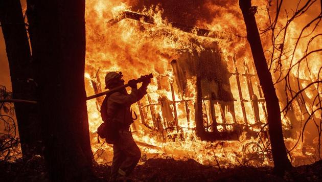 Thousands of firefighters spent a fifth day digging battle lines to contain California's worst ever wildfire as the wind-whipped flames cleaved a merciless path through the state's northern hills, leaving death and devastation in their wake. (AP) Thousands of firefighters spent a fifth day digging battle lines to contain California's worst ever wildfire as the wind-whipped flames cleaved a merciless path through the state's northern hills, leaving death and devastation in their wake. (AP)