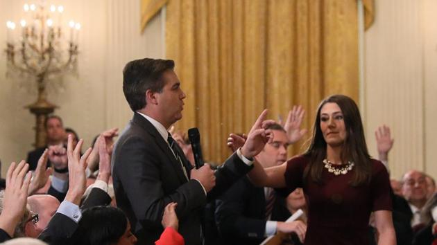 A White House intern reaches for and tries to take away the microphone held by CNN correspondent Jim Acosta as he questions US President Donald Trump during a news conference at the White House in Washington, US on November 7.(REUTERS)