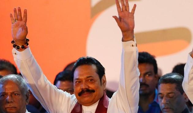 Sri Lanka's newly appointed Prime Minister Mahinda Rajapaksa waves at supporters during a rally near the parliament in Colombo, November 5(REUTERS)