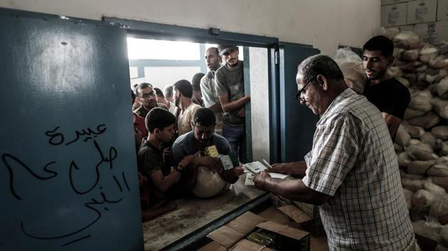 Palestinians receive aids at a United Nations food distribution centre in refugee camp. (AFP File Photo) Palestinians receive aids at a United Nations food distribution centre in refugee camp. (AFP File Photo)
