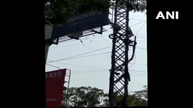 A screengrab of a TDP worker who climbed a power pole outside the party office in Hyderabad to seek a party ticket for his leader in Telangana (ANI/Twitter)(ANI)