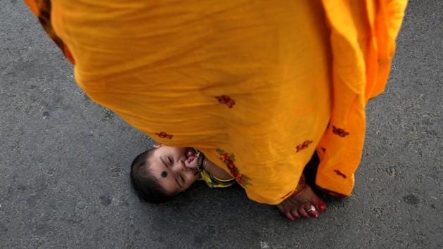 A woman steps over an infant in a ritual seeking blessings for the infant from the sun god during the festival in Kolkata. The challenging fasting is observed by lady folks or married women for the well-being of their sons and the happiness of family members. (Rupak De Chowdhuri / REUTERS) A woman steps over an infant in a ritual seeking blessings for the infant from the sun god during the festival in Kolkata. The challenging fasting is observed by lady folks or married women for the well-being of their sons and the happiness of family members. (Rupak De Chowdhuri / REUTERS)