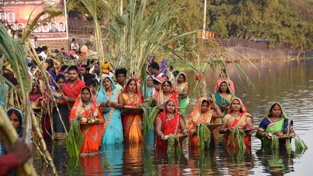 Women during the Chhath puja celebration at Chinchwad ghat on Tuesday. The four-day festival includes rigorous rituals such as holy bathing, fasting and offering prayers and food to the rising and setting sun.  (HT PHOTO) 