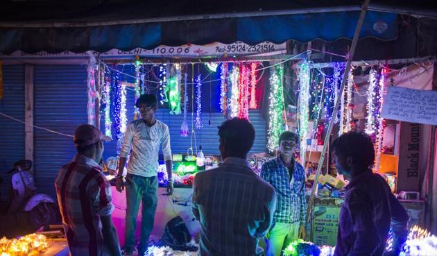 People shop for lights in a wholesale market during Diwali celebrations in Delhi. (Bloomberg) People shop for lights in a wholesale market during Diwali celebrations in Delhi. (Bloomberg)