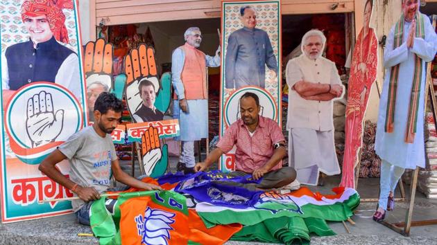 Workers prepare promotional materials for BJP and Congress ahead of the Rajasthan Assembly Elections, at Tripolia Bazaar in Jaipur, Wednesday. (PTI) Workers prepare promotional materials for BJP and Congress ahead of the Rajasthan Assembly Elections, at Tripolia Bazaar in Jaipur, Wednesday. (PTI)
