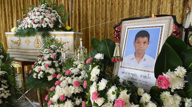 A portrait of 13-year-old Muay Thai boxer Anucha Tasako is displayed next to his coffin during a funeral at a Buddhist temple in Samut Prakan(AFP/Getty Images)
