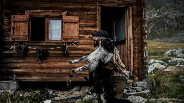 Meme plays with one of his dogs in front of his hut. He follows the sheep where they like to graze, helped by three dogs. It involves a lot of walking without really going anywhere. “I’m a nomad who goes nowhere,” he laughs. “I know only the pasture. Not what lies above or round the side.” (Jeff Pachoud / AFP)