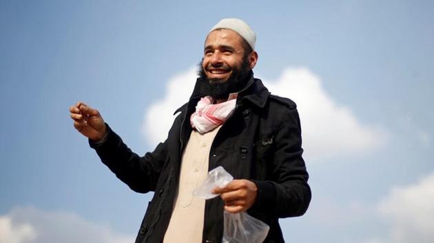 Haj Omar Abulhassan, a health practitioner, reacts with a plastic bag filled with bees used in the process of treatment for a variety of ailments on the roof of his home in Cairo. After reading about the benefits of bees in the Koran, Abulhassan, 30, decided five years ago to raise the insects and use the venom in alternative therapy. (Amr Abdallah Dalsh / REUTERS) Haj Omar Abulhassan, a health practitioner, reacts with a plastic bag filled with bees used in the process of treatment for a variety of ailments on the roof of his home in Cairo. After reading about the benefits of bees in the Koran, Abulhassan, 30, decided five years ago to raise the insects and use the venom in alternative therapy. (Amr Abdallah Dalsh / REUTERS)