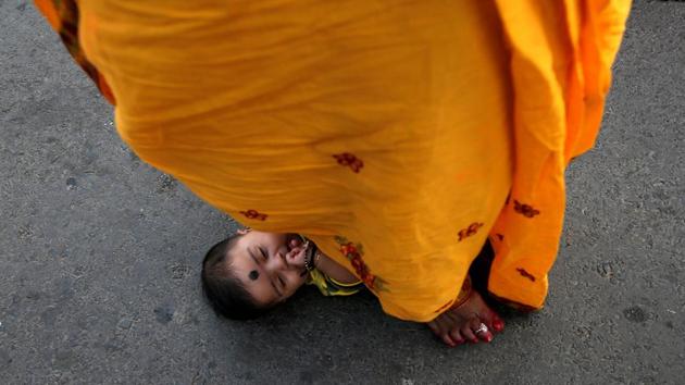 A Hindu woman steps over an infant in a ritual seeking blessings for the infant from the sun god during the religious festival of Chhath Puja in Kolkata, west Bengal. (Rupak De Chowdhuri / REUTERS) A Hindu woman steps over an infant in a ritual seeking blessings for the infant from the sun god during the religious festival of Chhath Puja in Kolkata, west Bengal. (Rupak De Chowdhuri / REUTERS)