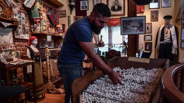 A man shows silk cocoons at a silk museum. In its heyday, the factory, founded by two Jewish brothers, Bohor and Eliezer Givre, exported silk as far as the French cities of Lyon and Bordeaux. But after World War II, textile makers turned to cheaper synthetic materials such as nylon, and the area’s once-prided infrastructure fell into disuse. A further blow came at the end of the 1990s, with the opening up of the silk market. (Aris Messinis / AFP) 