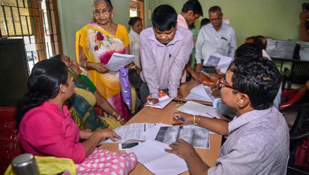 People verify the National Register of Citizens (NRC) forms to file claims and objections at an NRC centre in Guwahati. (PTI File) People verify the National Register of Citizens (NRC) forms to file claims and objections at an NRC centre in Guwahati. (PTI File)