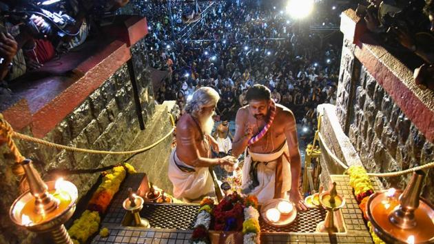 Amid a bitter standoff between the state government and protesters over the entry of women, the Sabarimala temple in Kerala opened for 64-day annual pilgrimage season on Friday(PTI)