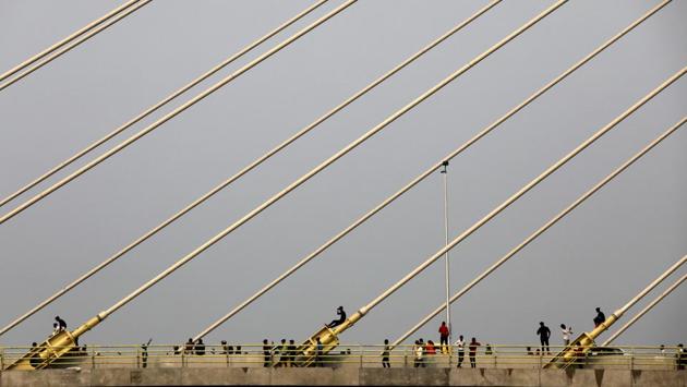 People stand on the newly inaugurated Signature Bridge over Yamuna river in New Delhi, India. (Anushree Fadnavis / REUTERS) People stand on the newly inaugurated Signature Bridge over Yamuna river in New Delhi, India. (Anushree Fadnavis / REUTERS)