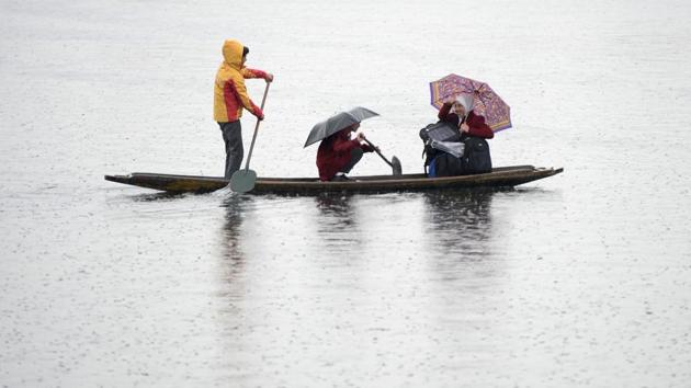 Kashmiri school children row their boat on Dal lake as they return home after school during a cold and rainy day in Srinagar, Jammu and Kashmir. (Tauseef Mustafa / AFP) Kashmiri school children row their boat on Dal lake as they return home after school during a cold and rainy day in Srinagar, Jammu and Kashmir. (Tauseef Mustafa / AFP)