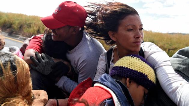 Central American migrants --mostly Hondurans-- moving towards the United States in hopes of a better life, ride onboard a truck near Guadalajara, Jalisco state, Mexico, as they continue their trek north on November 12, 2018. (Alfredo Estrella / AFP) Central American migrants --mostly Hondurans-- moving towards the United States in hopes of a better life, ride onboard a truck near Guadalajara, Jalisco state, Mexico, as they continue their trek north on November 12, 2018. (Alfredo Estrella / AFP)