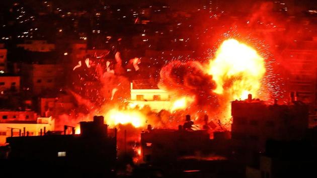 A ball of fire is seen above the building housing the Hamas-run television station al-Aqsa TV in the Gaza Strip during an Israeli air strike on November 12, 2018. (Mahmud Hams / AFP) A ball of fire is seen above the building housing the Hamas-run television station al-Aqsa TV in the Gaza Strip during an Israeli air strike on November 12, 2018. (Mahmud Hams / AFP)