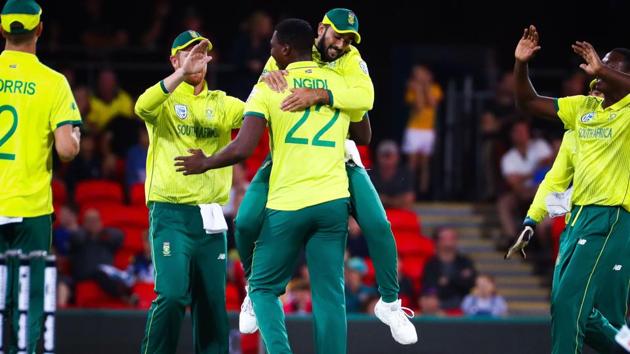 Lungi Ngidi of South Africa is embraced by Tabraiz Shamsi after dismissing Australia's Aaron Finch during the T20 international cricket match between Australia and South Africa at Metricon Stadium on the Gold Coast.(AFP)