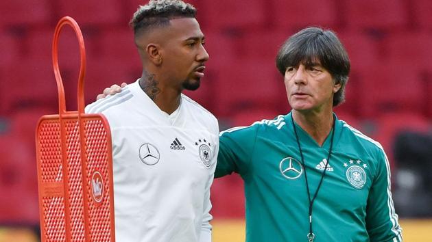 Jerome Boateng (L) and German coach Joachim Low take part in a training session a day before the UEFA Nations League.(AFP)