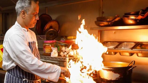 A chef cooks curry in an Indian restaurant kitchen in Chobham. (Bloomberg) A chef cooks curry in an Indian restaurant kitchen in Chobham. (Bloomberg)