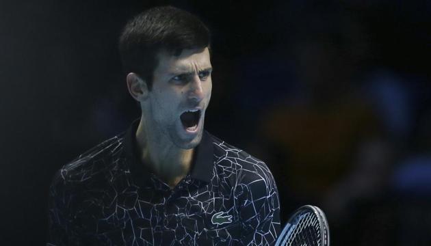 Novak Djokovic of Serbia celebrates winning a point against Kevin Anderson of South Africa in their ATP World Tour Finals singles tennis match at the O2 Arena in London, Saturday Nov. 17, 2018(AP)