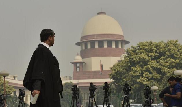 Representational image of a man walks in front of the Supreme Court in New Delhi(Sanjeev Verma/HT PHOTO)