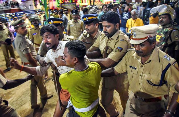 Police personnel detain the devotees who were staging 'Namajapa' protest against the police restrictions at Sannidhanam, in Sabarimala.(PTI Photo)