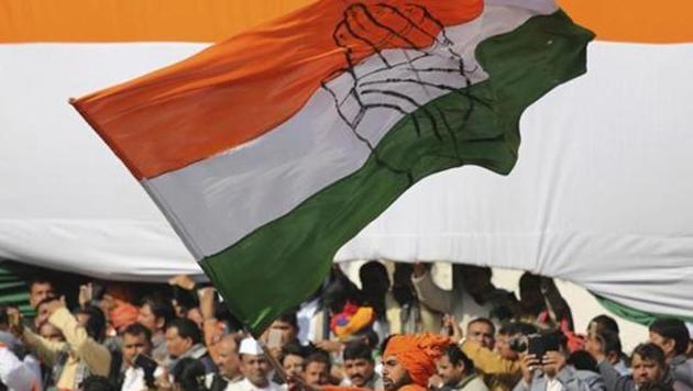 A Congress party worker waves the party flag during a function.(AP)