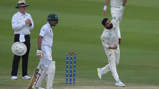 New Zealand spinner Ajaz Patel (R) delivers the ball as Pakistani batsman Babar Azam looks on during the second day of the first Test cricket match between Pakistan and New Zealand at the Sheikh Zayed International Cricket Stadium in Abu Dhabi. (AFP/Getty Images) New Zealand spinner Ajaz Patel (R) delivers the ball as Pakistani batsman Babar Azam looks on during the second day of the first Test cricket match between Pakistan and New Zealand at the Sheikh Zayed International Cricket Stadium in Abu Dhabi. (AFP/Getty Images)