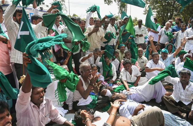 Sugarcane farmers raise slogans against the state government demanding clearance of their pending arrears by sugar factories for the cane supplied and announcement of purchase price for sugarcane for the current season, in Bengaluru. (Shailendra Bhojak / PTI) Sugarcane farmers raise slogans against the state government demanding clearance of their pending arrears by sugar factories for the cane supplied and announcement of purchase price for sugarcane for the current season, in Bengaluru. (Shailendra Bhojak / PTI)