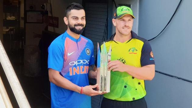 India skipper Virat Kohli (left) and Australia skipper Aaron Finch unveil the T20I series trophy in Brisbane. (BCCI) India skipper Virat Kohli (left) and Australia skipper Aaron Finch unveil the T20I series trophy in Brisbane. (BCCI)