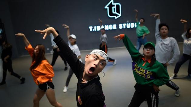 In mid-January a leaked government directive banned airtime for “artists with tattoos, hip-hop music” and content that “conflicts” with party morals. Zhang Jianpeng, a well-known street dancer in China, said he was forced to remove his makeup before going onstage during a televised dance competition. (Wang Zhao / AFP)
