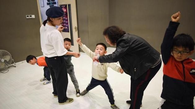 “I want my son to be more extroverted. Kids these days lack spunk,” explained Liu Li, the mother of a shy four-year-old. It is not uncommon for children as young as three to take English lessons, piano classes and other more traditional after-school activities in China, where the pressure to compete with other students can be all-consuming. (Wang Zhao / AFP)