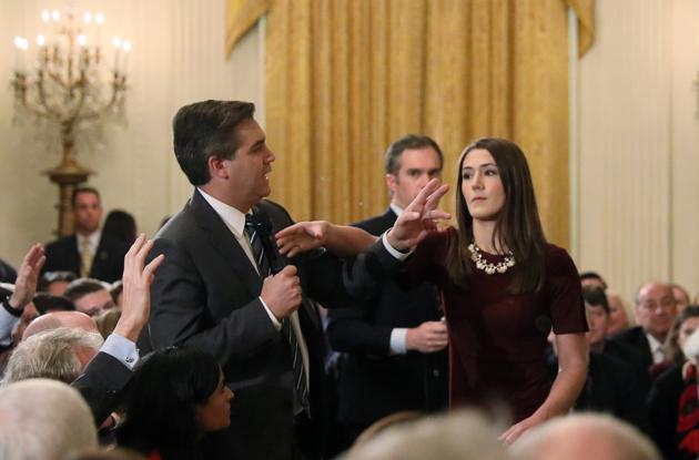 A White House intern reaches for and tries to take away the microphone held by CNN correspondent Jim Acosta as he questions U.S. President Donald Trump during a news conference at the White House in Washington on November 7.(REUTERS)